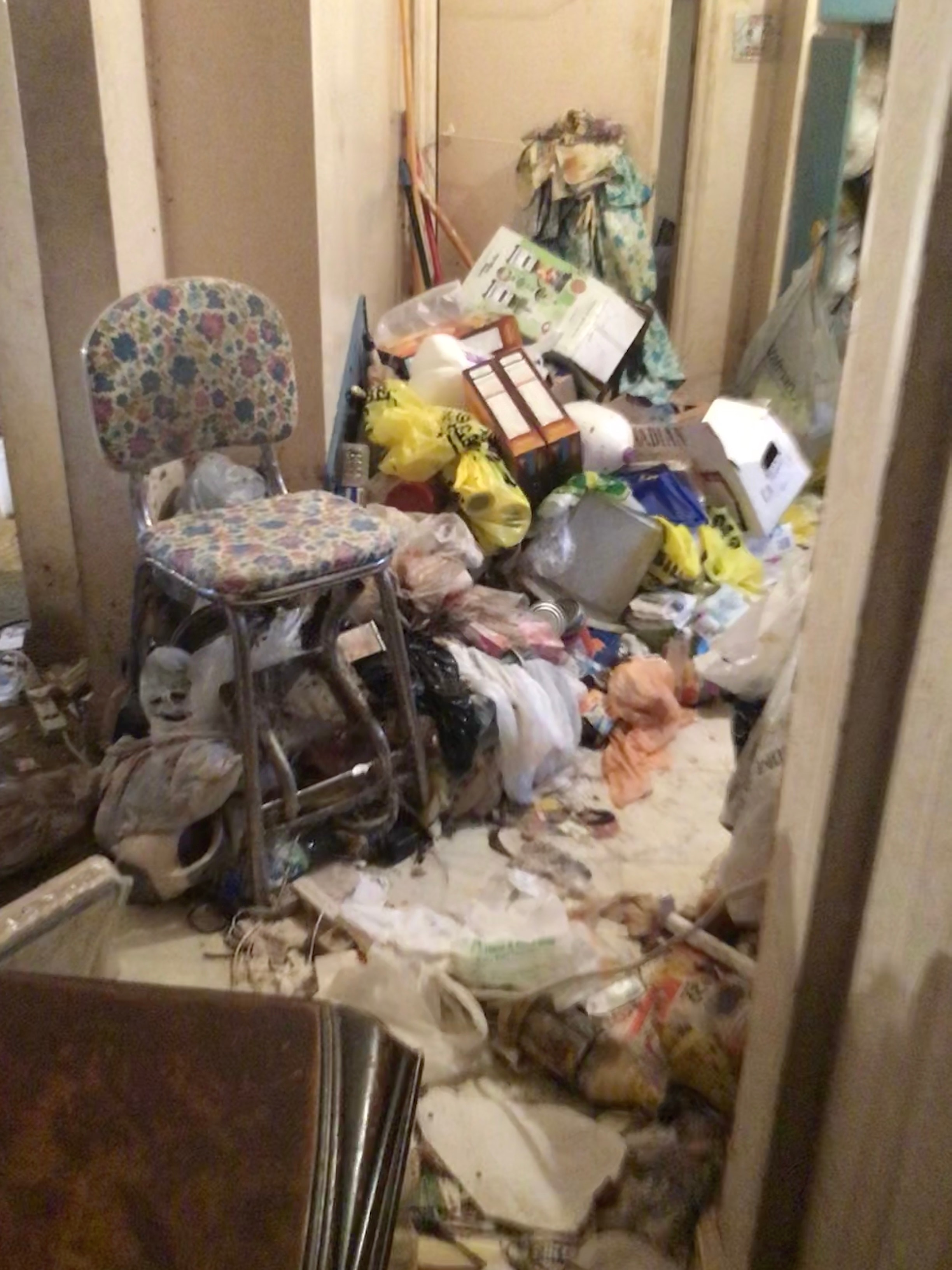 Cluttered room with accumulated belongings — residential conditions Entrust The Care handles